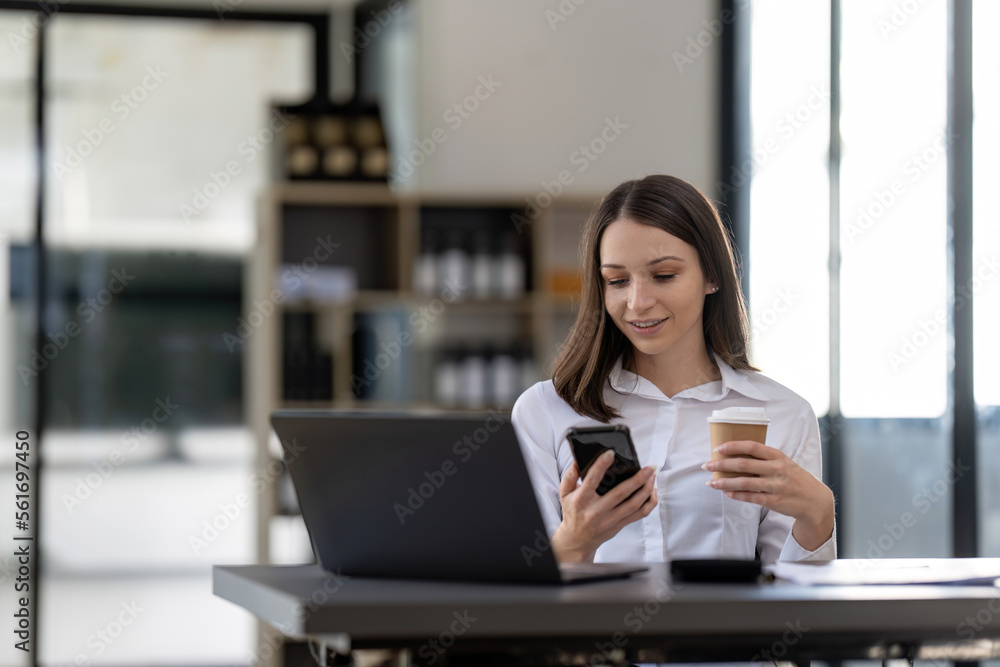 Business woman using smartphone for do math finance on wooden desk in office, tax, accounting, financial concept Business woman using smartphone for do math finance on wooden desk in office, tax, accounting, financial concept