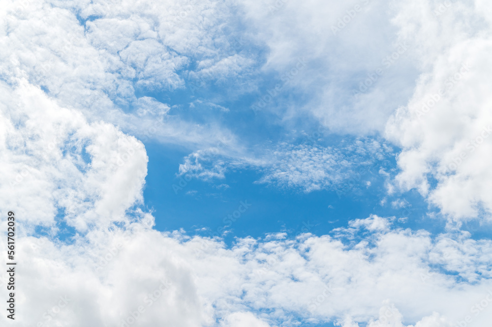 Naklejka premium Nature background from white clouds in sunny day. Beautiful white fluffy clouds in blue sky.