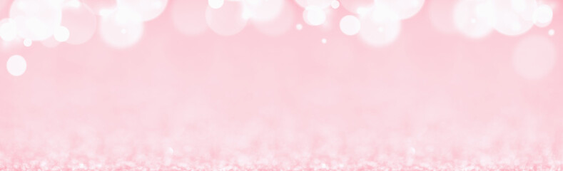 St Valentines day pink background top border wide banner. Love or wedding concept with bokeh lights blurred defocused glitter