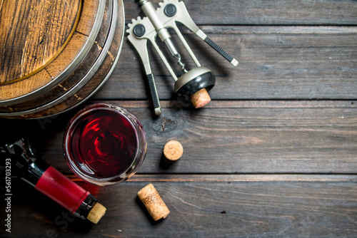 Wine background. A barrel of red wine with a corkscrew.