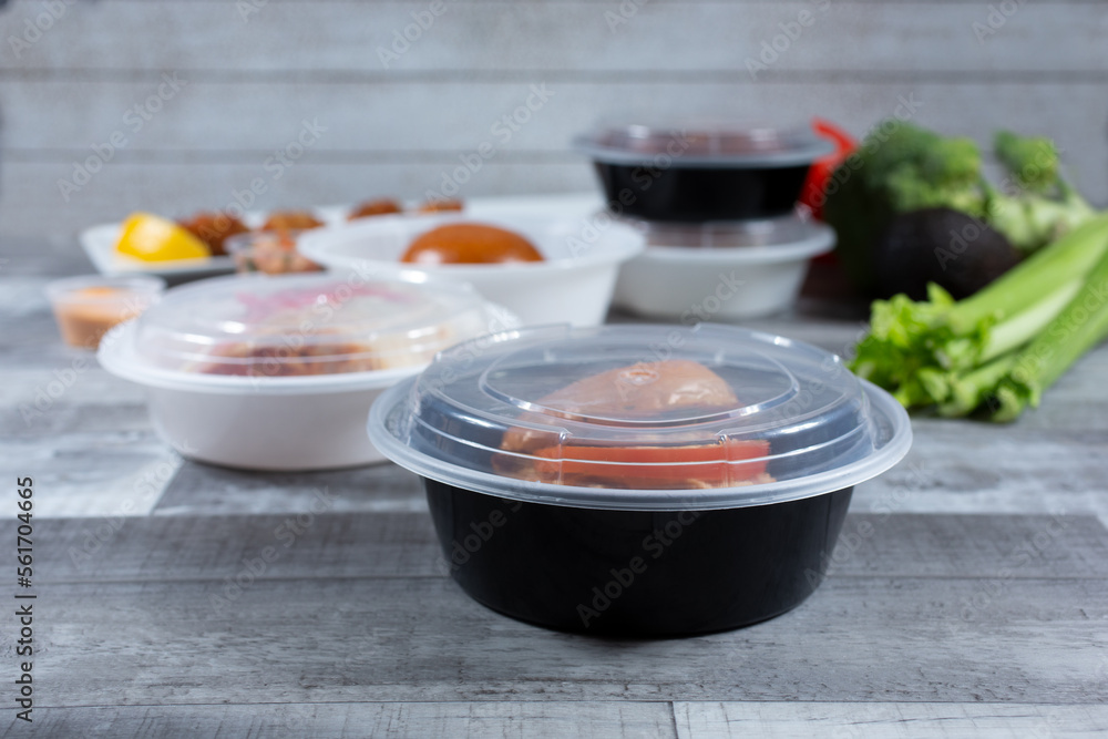 A view of food in several to-go plastic containers.