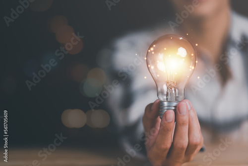 solution concept and demonstrating leadership strategies,that lead the business in a successful direction,with innovation and brain power from brainstorming,light bulb in human hand