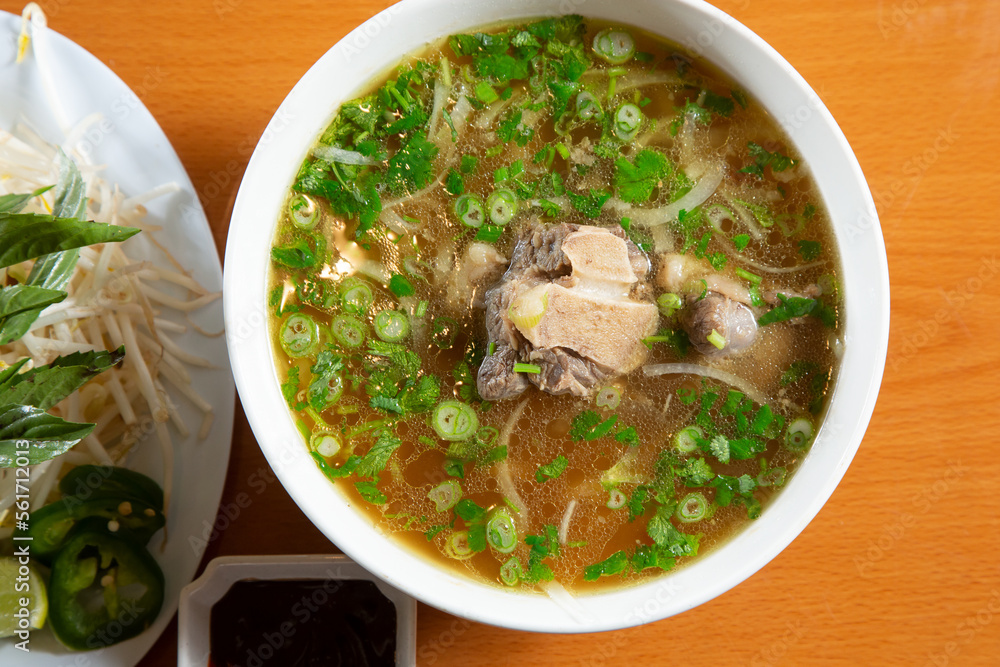 A top down view of a bowl of oxtail pho. A top down view of a bowl of oxtail pho.