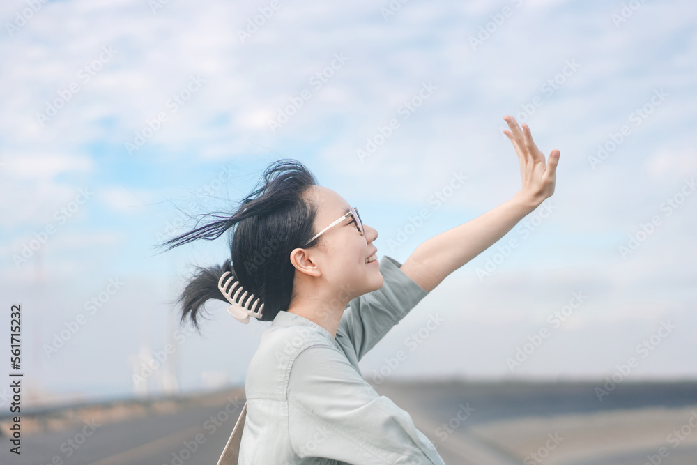Happy smile young adult asian woman side view japanese tone photography with blue sky Happy smile young adult asian woman side view japanese tone photography with blue sky