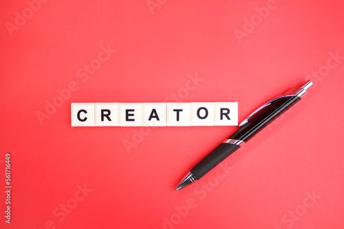 pen with the word creator. creator designer concept. create video or photographer content