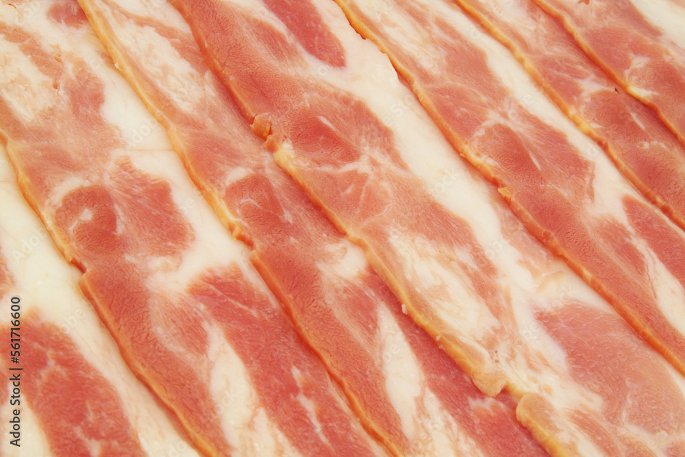 Many fresh tasty bacon slices close up. Many fresh tasty bacon slices close up.