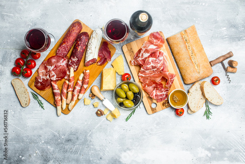 Antipasto background. Different Italian snacks with red wine.