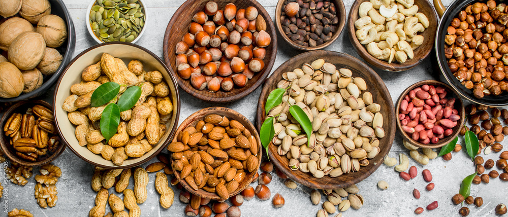 Assortment of different nuts in bowls.