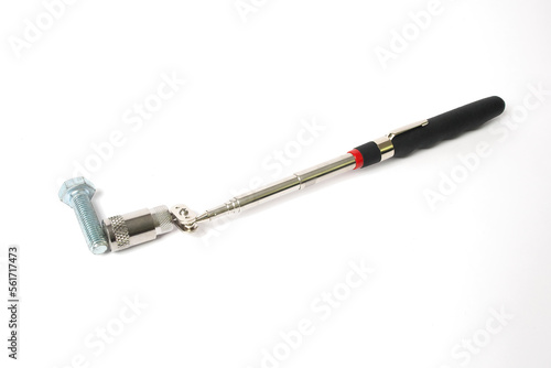 Magnet with a telescopic tube and a flashlight on a white background. A handy tool for car repair.