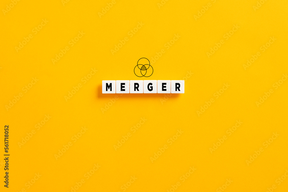 White letter blocks on yellow background with the word merger. Business company merger concept.