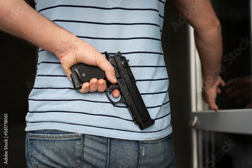 Photography an armed criminal with a dhrt pistol enters the premises