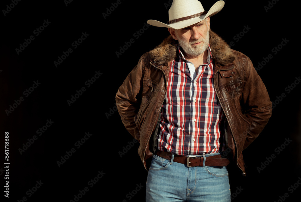Portrait of adult man in cowboy hat against black background Portrait of adult man in cowboy hat against black background
