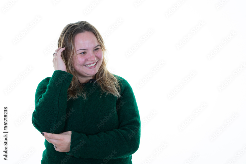 Plus size woman model with hand in hair blond smiling looking blank copy space posing in studio white background Plus size woman model with hand in hair blond smiling looking blank copy space posing in studio white background