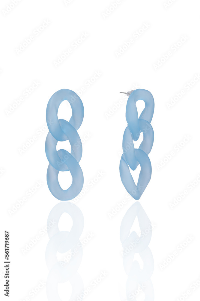 Fototapeta premium Subject shot of translucent light blue stud earrings made as chain links. The original earrings are isolated on the white background. Front and side views. Vogue accessory for ladies and girls.