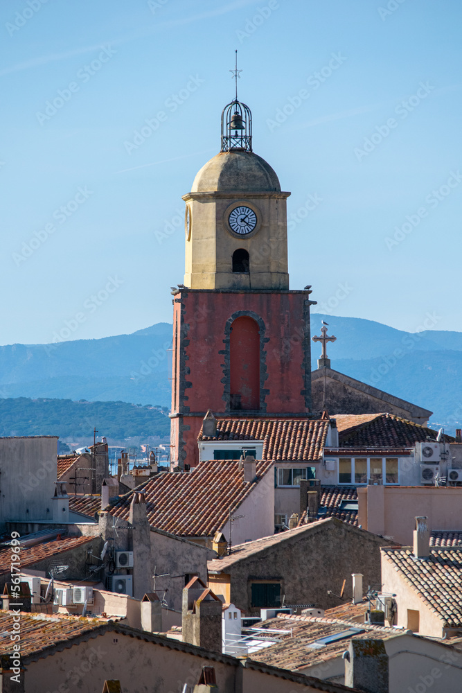 Saint Tropez church tower with clock against blue sky