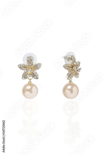 A subject shot of elegant stud earrings. Earrings in the shape of a flower are decorated with crystals and a pendant in the form of a pink pearl bead. The earrings are isolated on a white background.