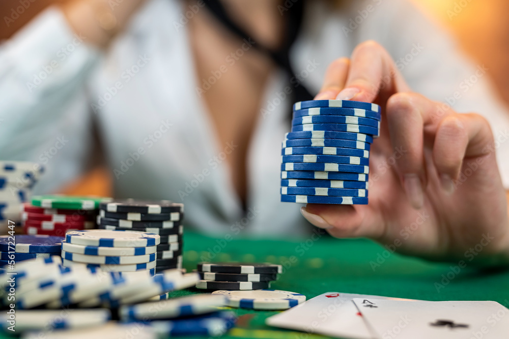 woman in a casino with many chips that she wraps up after a big win in poker. poker concept.