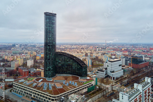 Drone flight over Wroclaw cityscape with Sky Tower skyscraper. Aerial view of modern european city in Poland