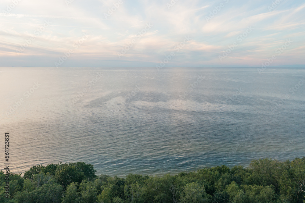 Top view of Narva Bay on a summer evening. Toila Oru Park. The sky is a pastel color. The rich greenery of the park. Space for text. Natural background.