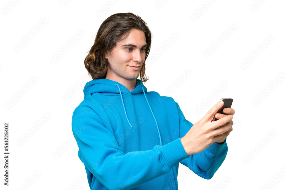 Young handsome man isolated on green chroma background sending a message or email with the mobile Young handsome man isolated on green chroma background sending a message or email with the mobile