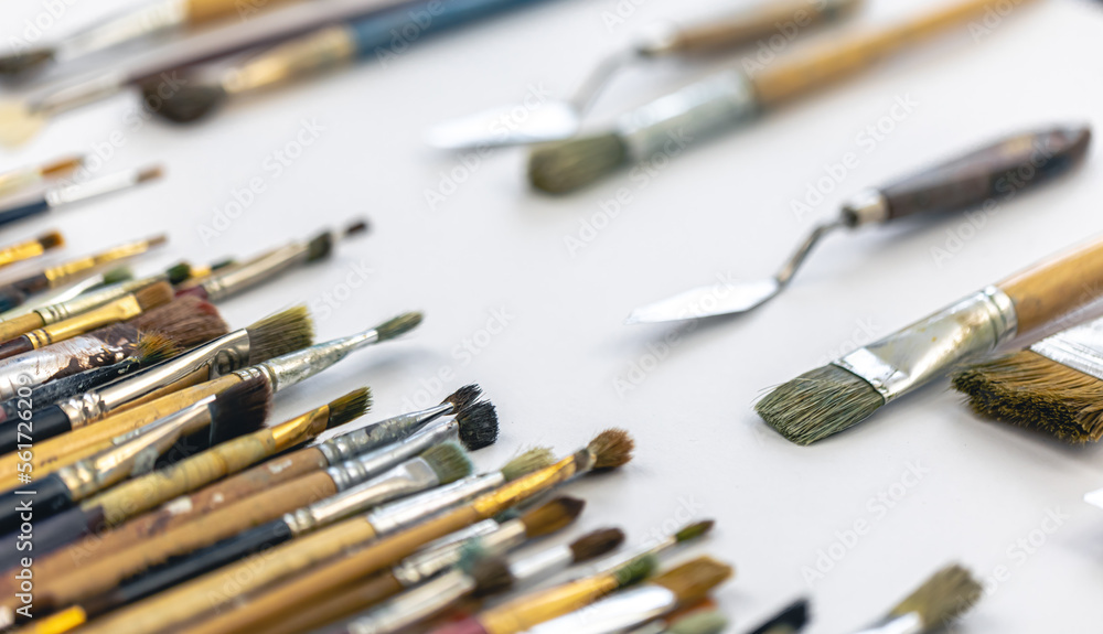 Fototapeta premium Paint brushes stained with paint, close-up, macro shot.