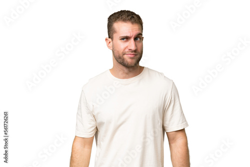 Young handsome caucasian man isolated on green chroma background having doubts while looking side