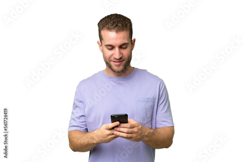 Young handsome caucasian man isolated on green chroma background sending a message with the mobile © luismolinero