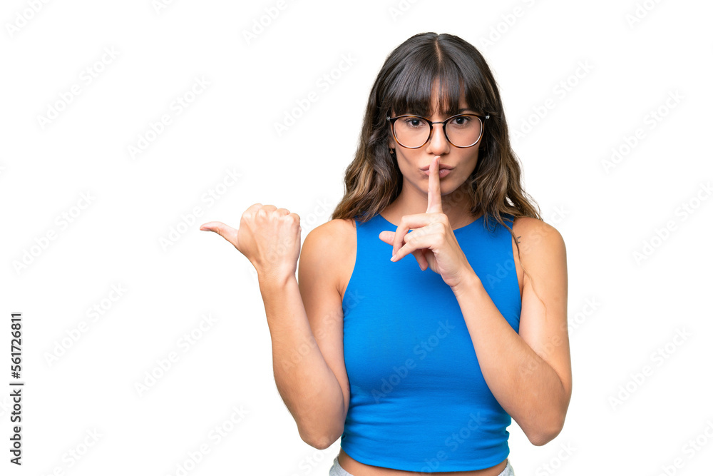 Young caucasian woman over isolated background pointing to the side and doing silence gesture Young caucasian woman over isolated background pointing to the side and doing silence gesture