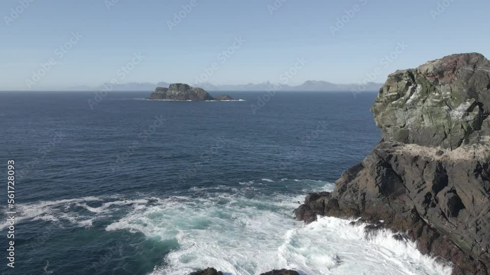 in the solitude of the end of the world on a rock looking at the horizon over the sea in the solitude of the end of the world on a rock looking at the horizon over the sea