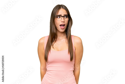 Young pretty caucasian woman over isolated background doing surprise gesture while looking to the side