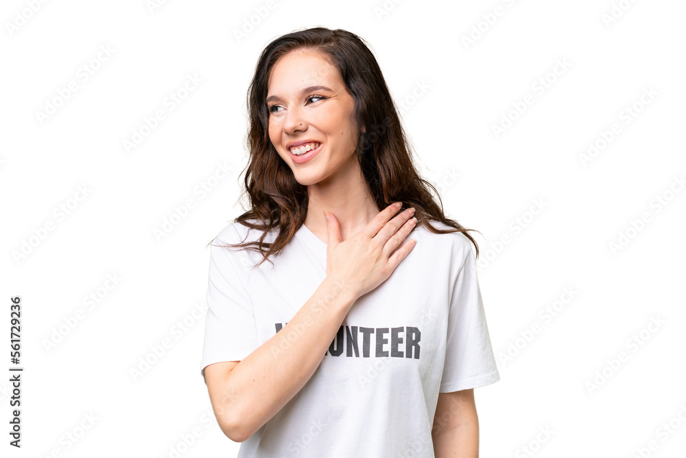 Young volunteer caucasian woman over isolated background looking up while smiling Young volunteer caucasian woman over isolated background looking up while smiling