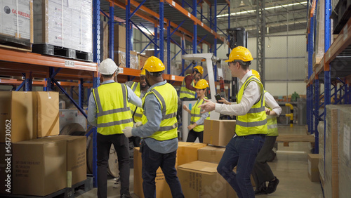 Teamwork group of multi ethnic workers working in large warehouse retail store industry factory. Stock storage. Cargo in ecommerce and logistic concept. Depot. People lifestyle. Shipment service.