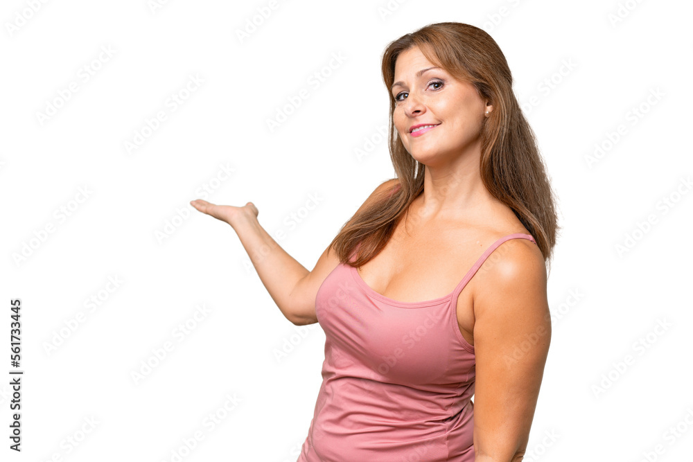 Middle-aged caucasian woman over isolated background extending hands to the side for inviting to come Middle-aged caucasian woman over isolated background extending hands to the side for inviting to come