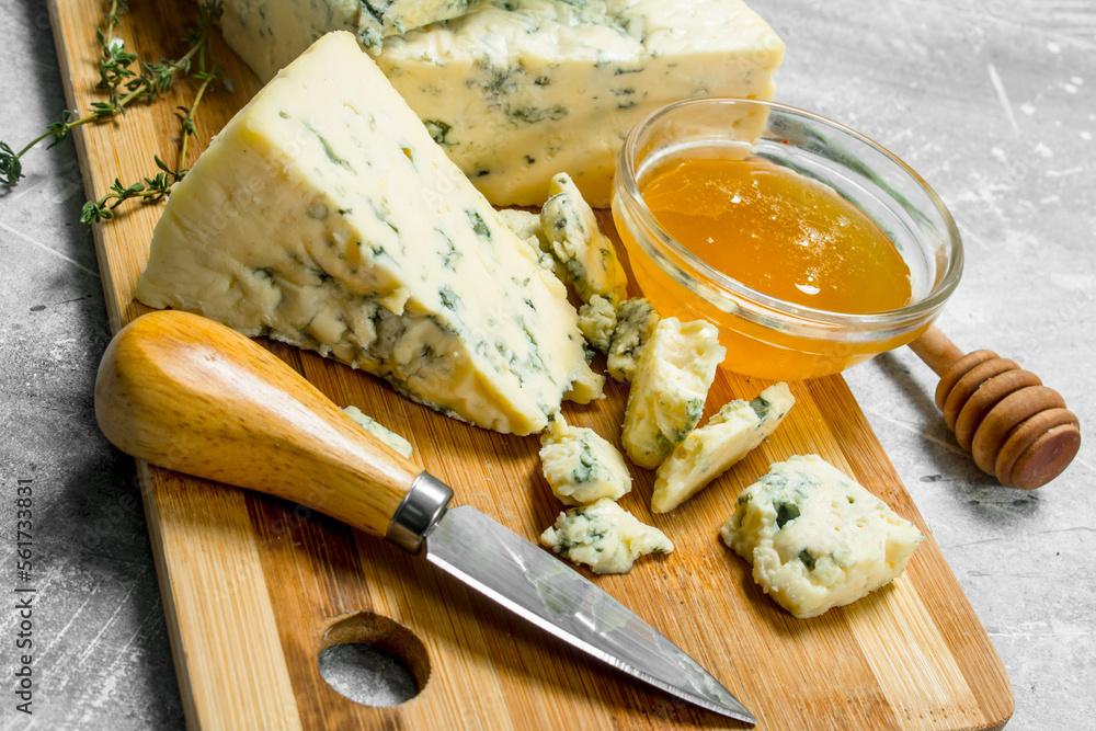 Blue cheese with honey on a wooden Board.