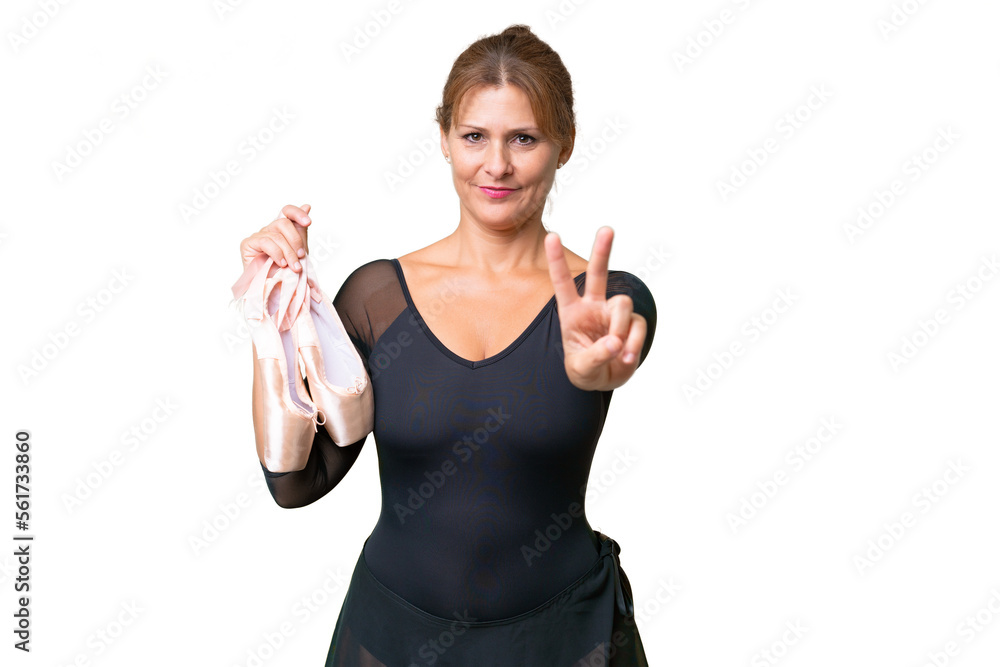 Middle-aged caucasian woman practicing ballet over isolated background smiling and showing victory sign Middle-aged caucasian woman practicing ballet over isolated background smiling and showing victory sign