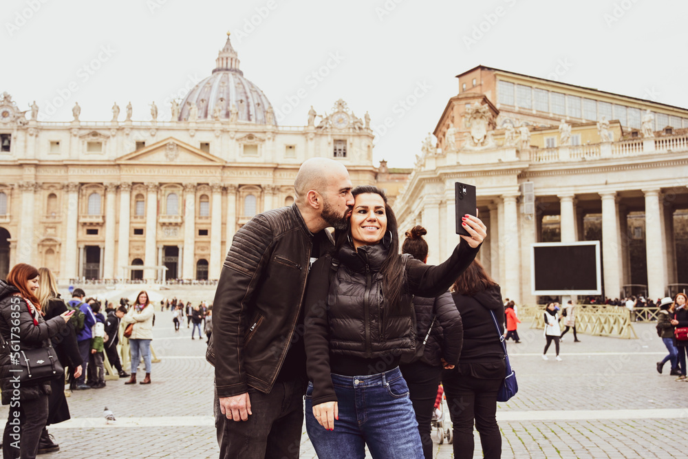 Happy  Tourists  couple traveling at Rome, Italy, poses in front of   Vatican City  at, Rome, Italy