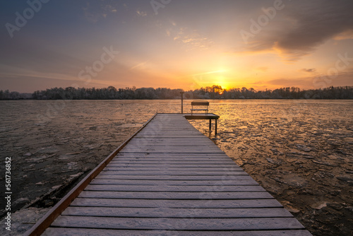 frosted pier over a frozen river during a beautiful sunrise © Mike Mareen