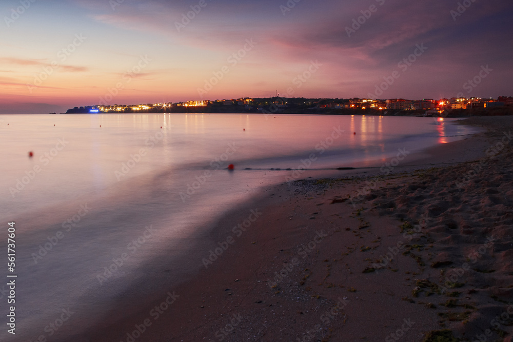 Obraz premium beach on the black sea at dawn. leisure and travel background in summer. velvet season. red clouds on the sky