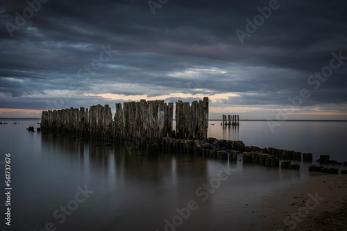 Poland, Pomerania, Gdynia, Storm clouds over groyne in Babie Doly photo