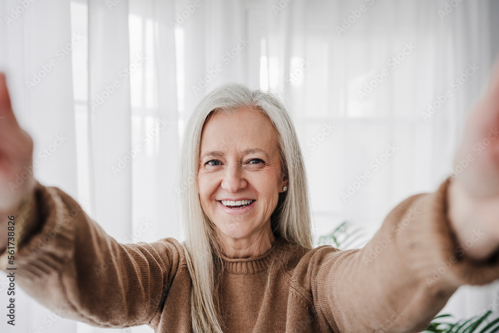 Smiling mature woman taking selfie at home Smiling mature woman taking selfie at home