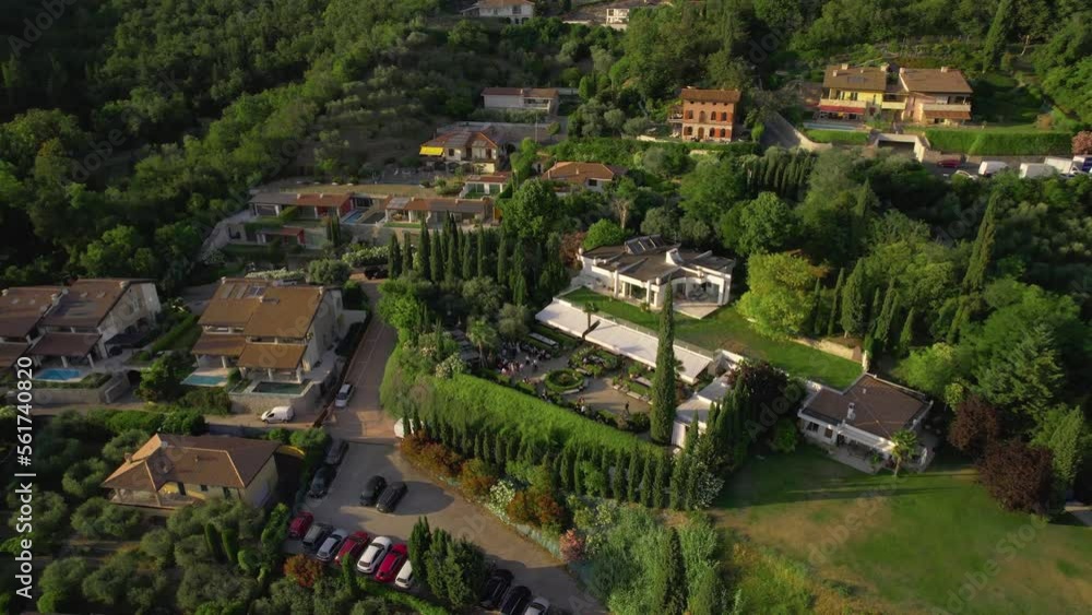 Aerial view of a village with lovely villas located in northern Italy, on the shores of Lake Garda. Beautiful view in a warm summer day. Party at an Italian villa. Aerial view of a village with lovely villas located in northern Italy, on the shores of Lake Garda. Beautiful view in a warm summer day. Party at an Italian villa.