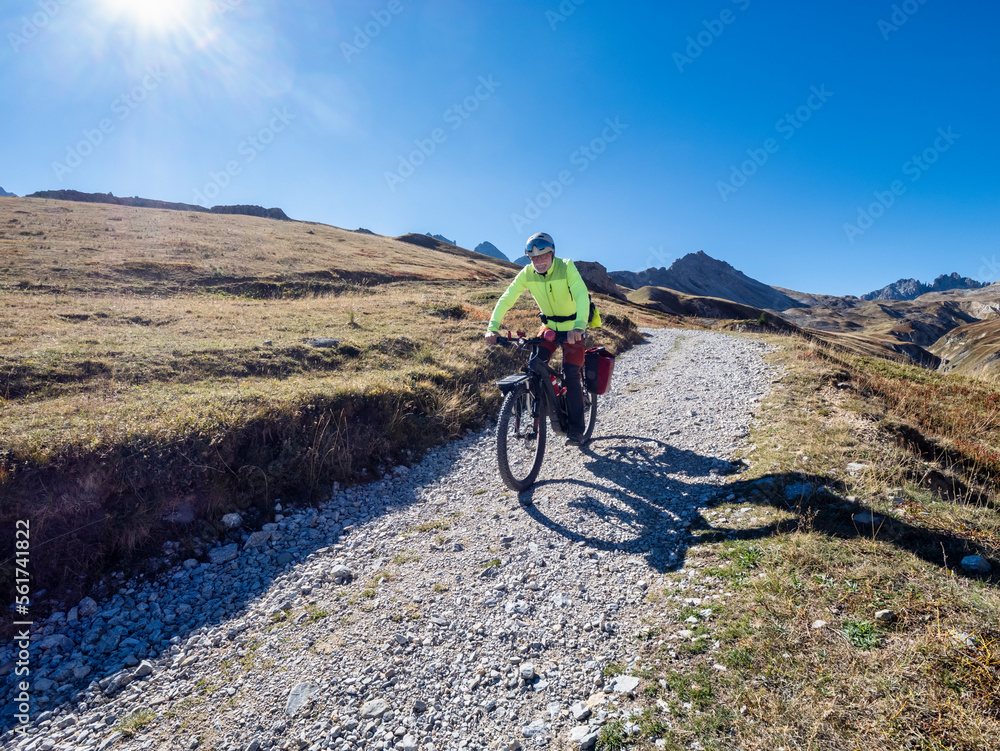 Senior man riding mountain bike on pathway, Vanoise National Park, France Senior man riding mountain bike on pathway, Vanoise National Park, France