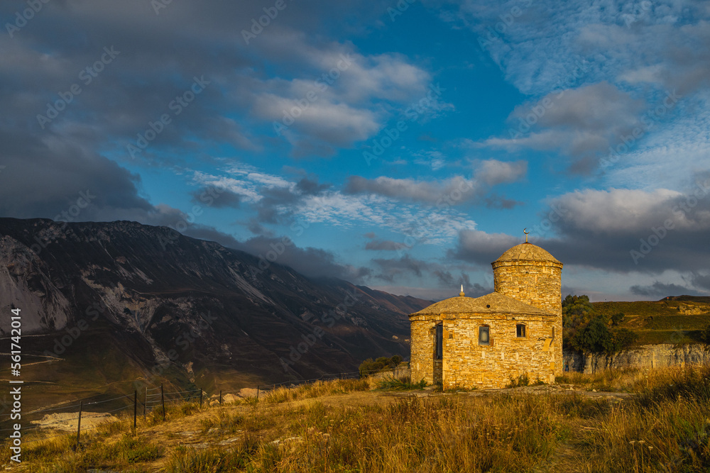 A small stone mosque against the backdrop of picturesque green mountains. Republic of Dagestan A small stone mosque against the backdrop of picturesque green mountains. Republic of Dagestan