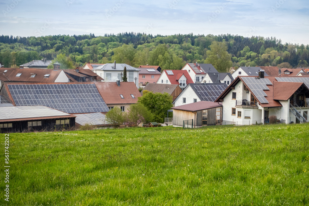 Houses with solar panels in front of green field Houses with solar panels in front of green field