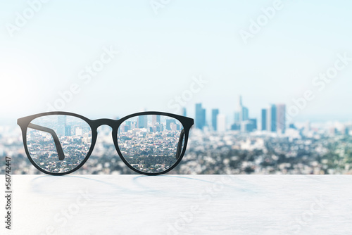 Look through glasses at blurred city with mock up place on sky backdrop. Vision and perspective concept. 3D Rendering.