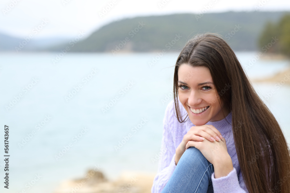 Happy teen smiling in a lake looking at camera Happy teen smiling in a lake looking at camera