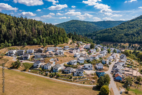 Germany, Baden-Wurttemberg, Bad Herrenalb, Aerial view of new modern development area with forested hills in background photo