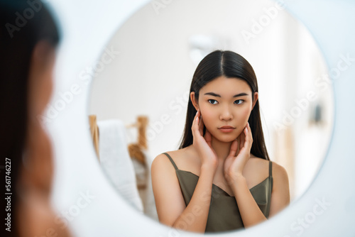 woman looking at mirror
