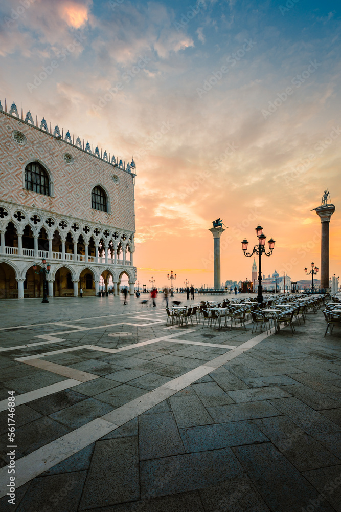 St. Mark's Square (Piazza San Marco) of Venice at dawn with people walking around
