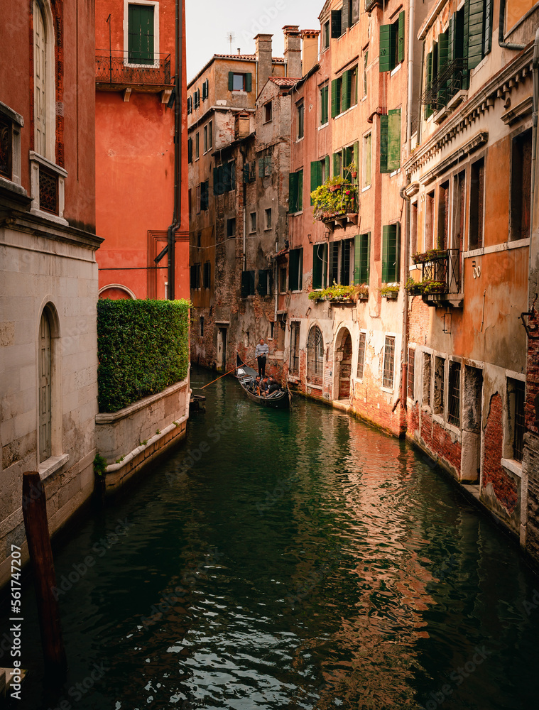Characteristic canal of Venice with gondolier while sailing